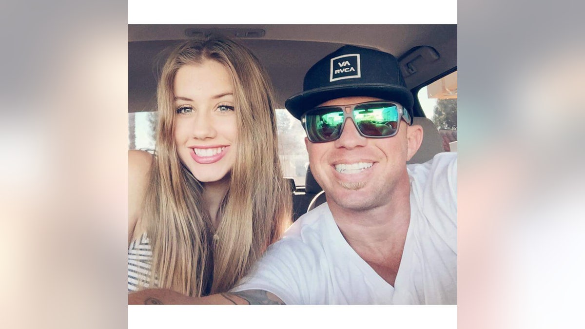 James Kulstad wearing a achromatic garment and sunglasses posing pinch a chapeau wrong a car pinch a smiling woman.