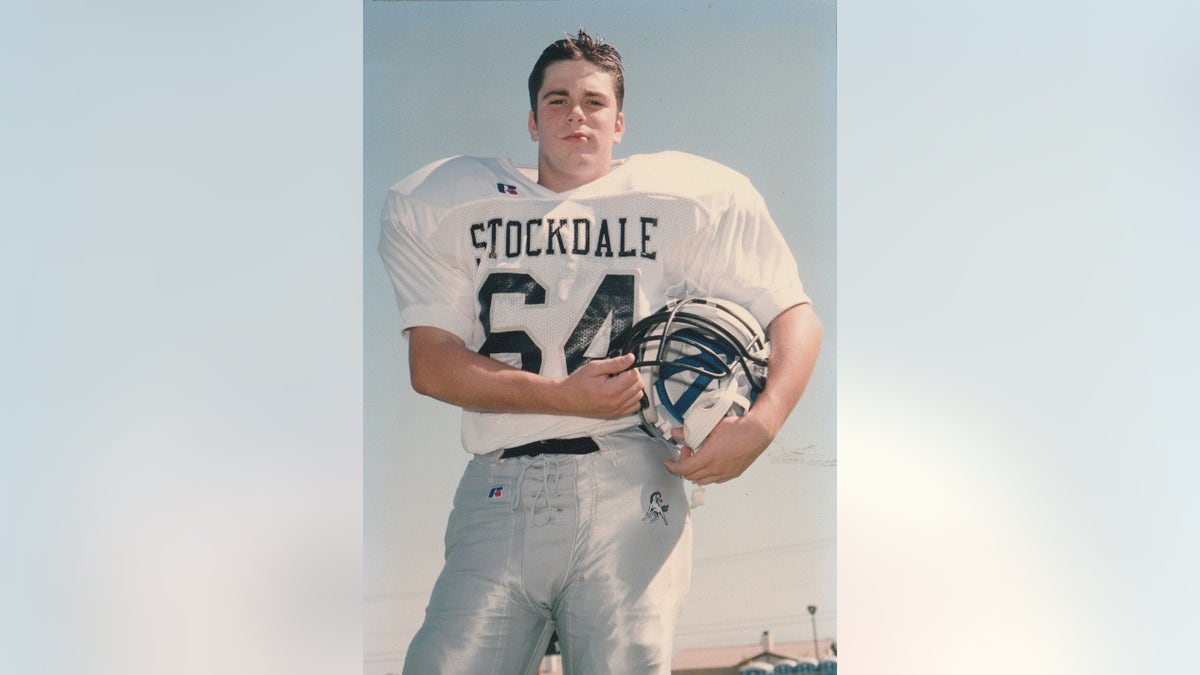 A young Micah Holsenbake successful a shot uniform.