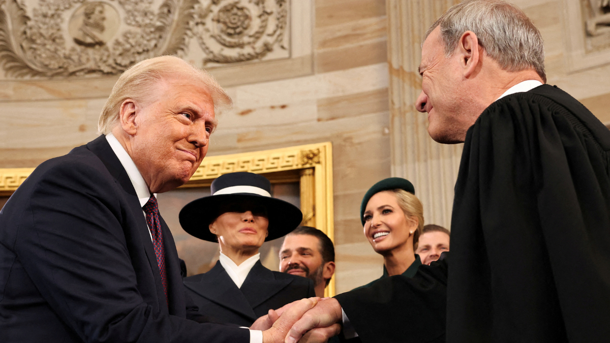U.S. President Donald Trump shakes hands with U.S. Supreme Court Chief Justice John Roberts (R) as Melania Trump, Donald Trump Jr. and Ivanka Trump look on after being sworn in during inauguration ceremonies in the Rotunda of the U.S. Capitol on January 20, 2025 in Washington, DC. Chip Somodevilla/Pool via REUTERS/File Photo