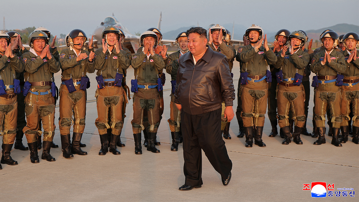 Kim Jong Un is applauded by military pilots