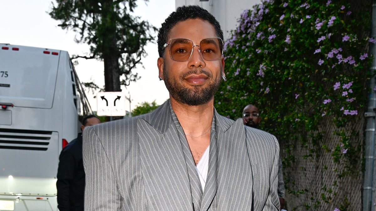 Jossi Smollett in a gray suit and sunglasses