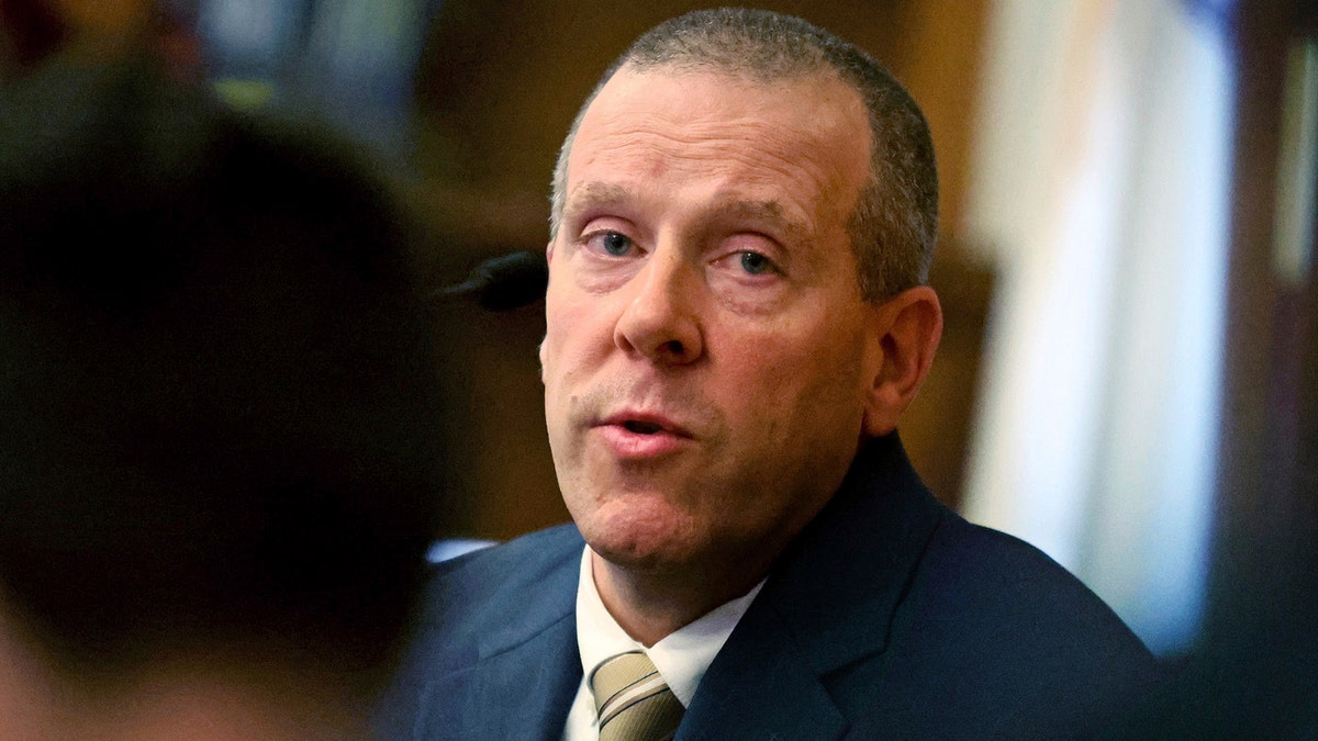 Massachusetts State Trooper Lt. Kevin O'Hara wearing a dark blue suit, white shirt and brown tie as he testifies at Karen Read's second trial