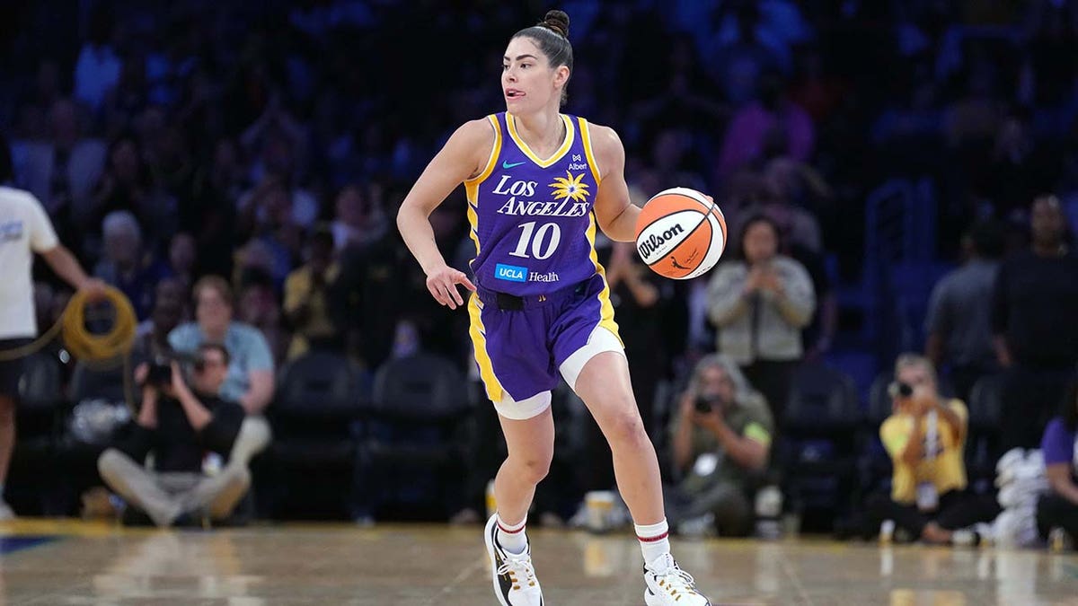 Kelsey Plum dribbles