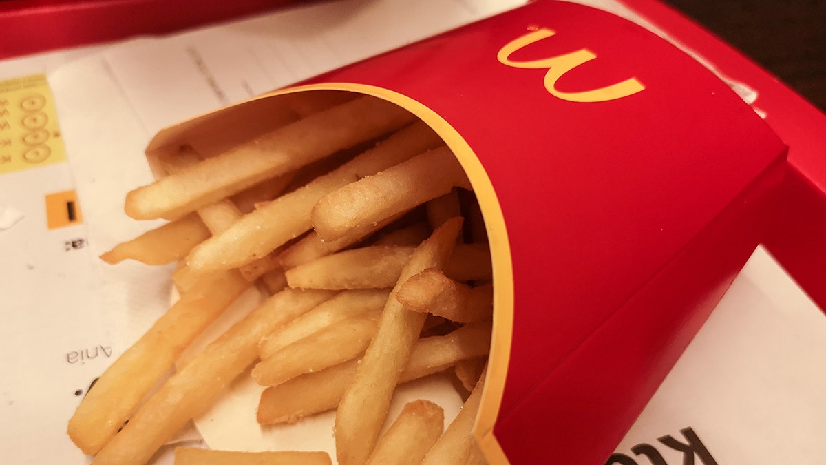 McDonald's fries spill out of the carton on a tray at a location in Poland.