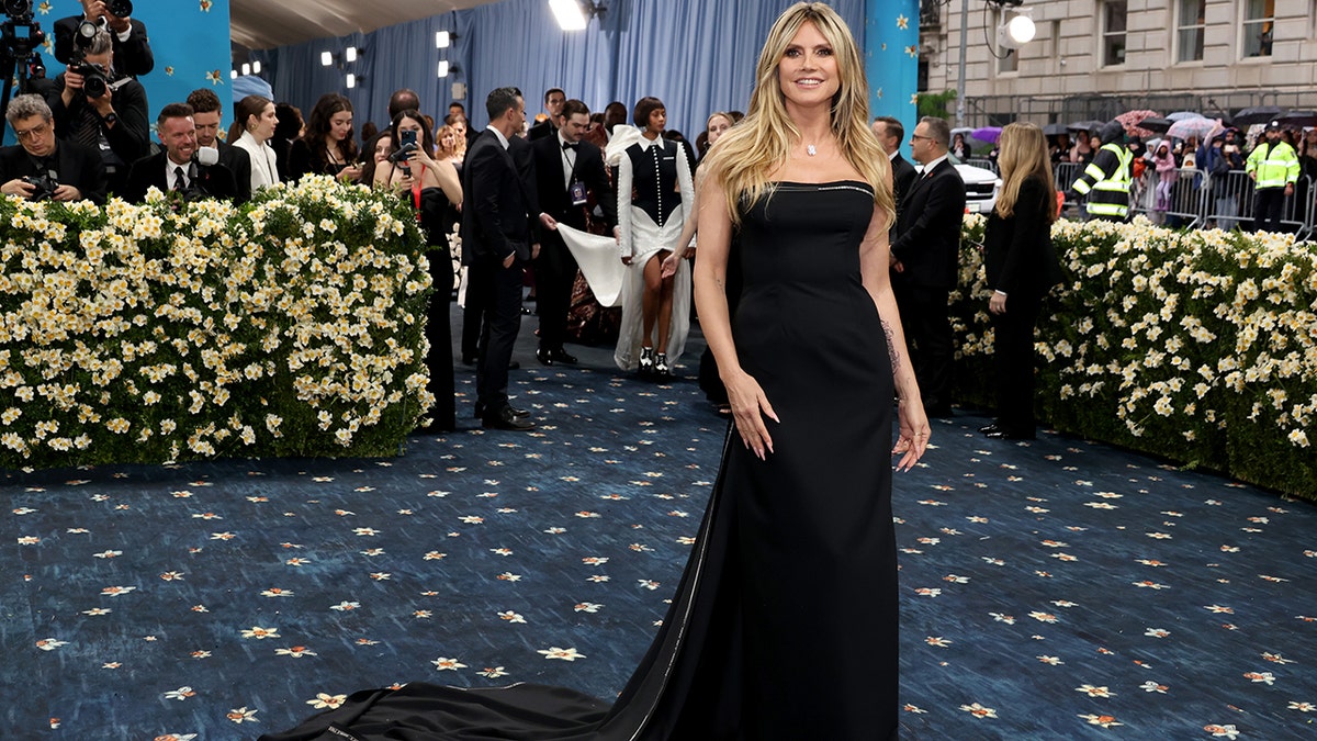 Heidi Klum at the Met Gala in a black strapless dress.