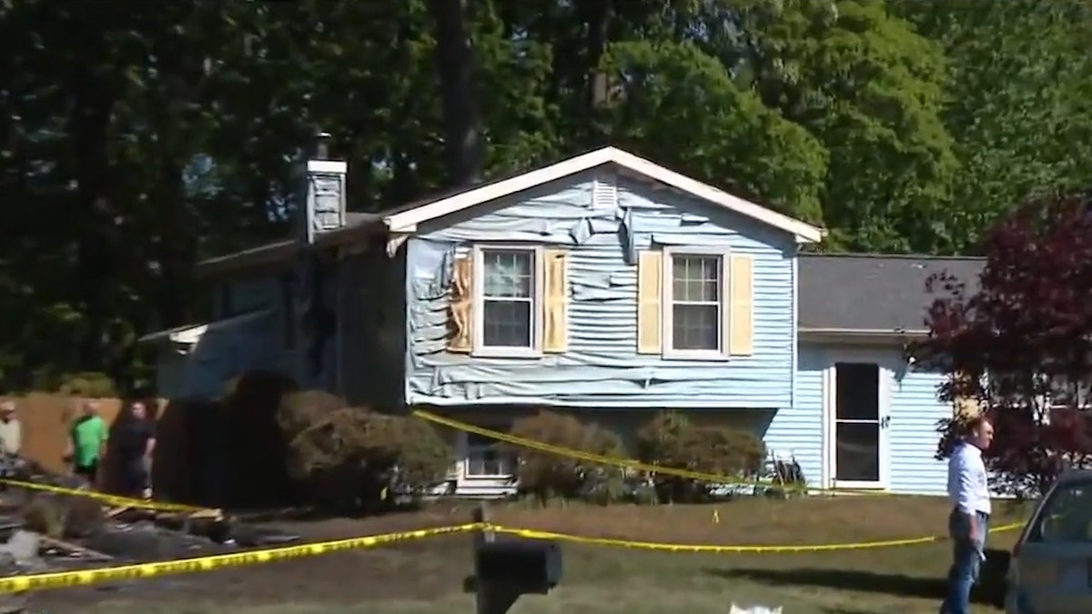 blue house with exterior damages