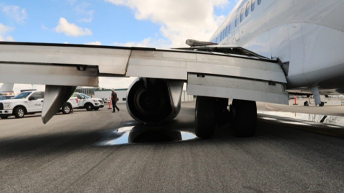 left airplane wing touching tarmac