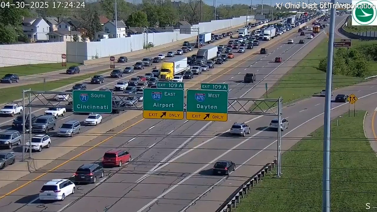 aerial view of red car stopping in middle lane of busy highway