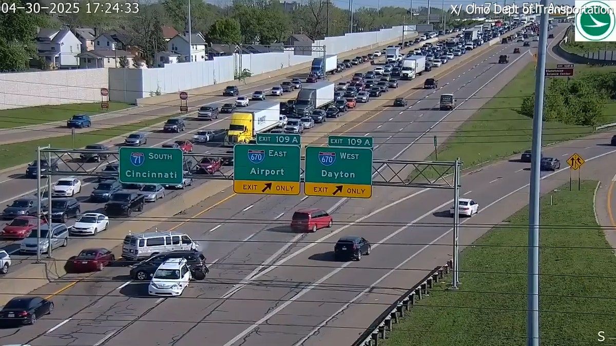aerial view of red car leaving scene after causing mutli-car crash