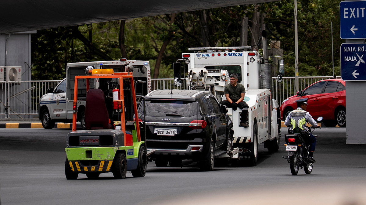 Workers tow the vehicle that crashed