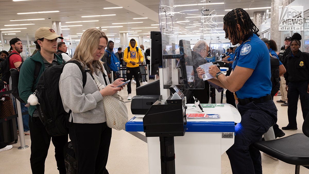 Young travelers present REAL ID's at the airport on day one of the program being in effect