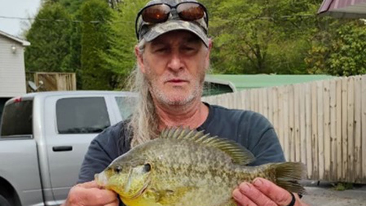 Man holding record-breaking fish