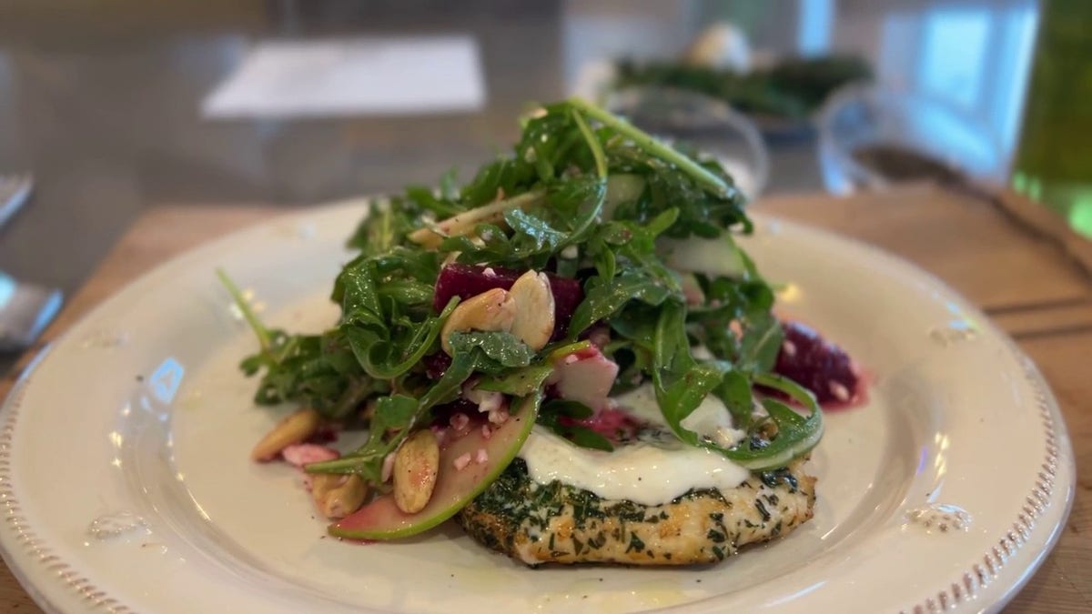 A seared herb chicken paillard with a toasted coriander Greek yogurt spread and a spring harvest salad.