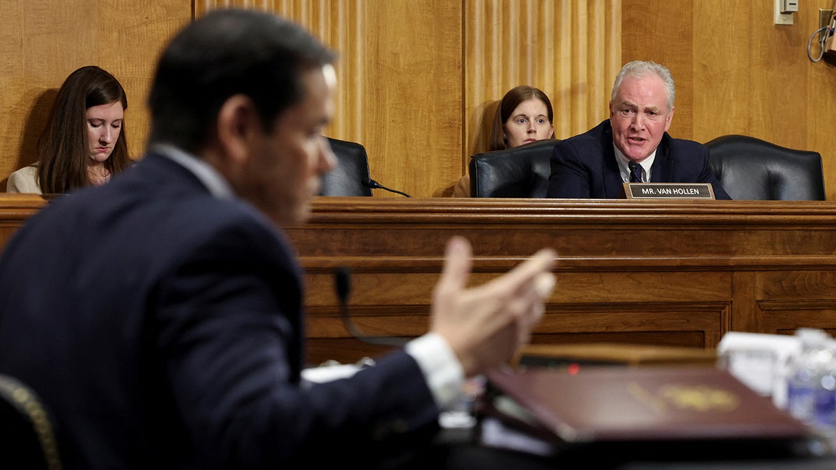 Senator Chris van Hollen speaks as Secretary of State Marco Rubio gestures