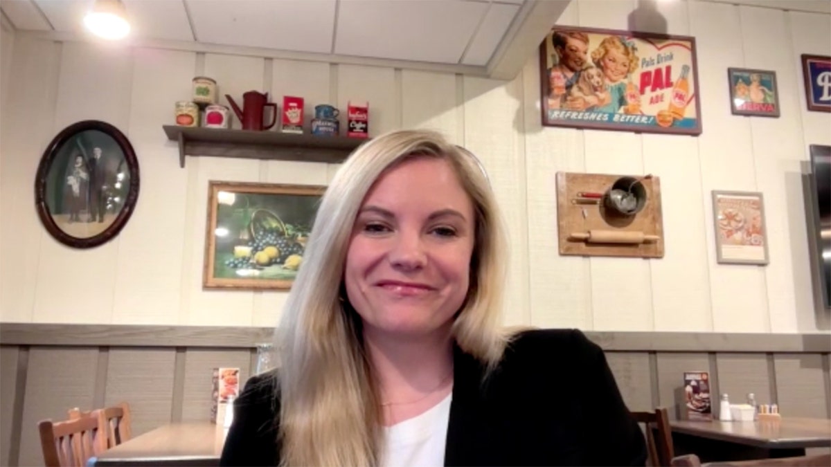 Sarah Moore, chief marketing officer at Cracker Barrel, smiles inside a restaurant.