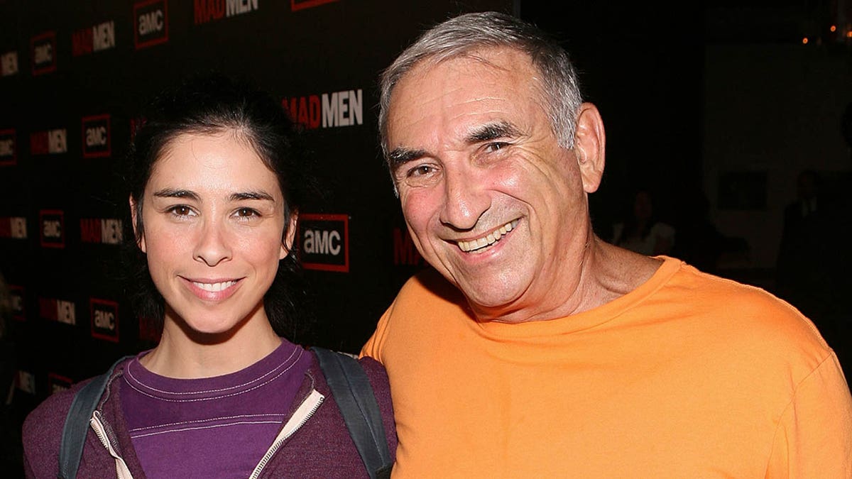 sarah silverman smiling with her father donald silverman on a red carpet