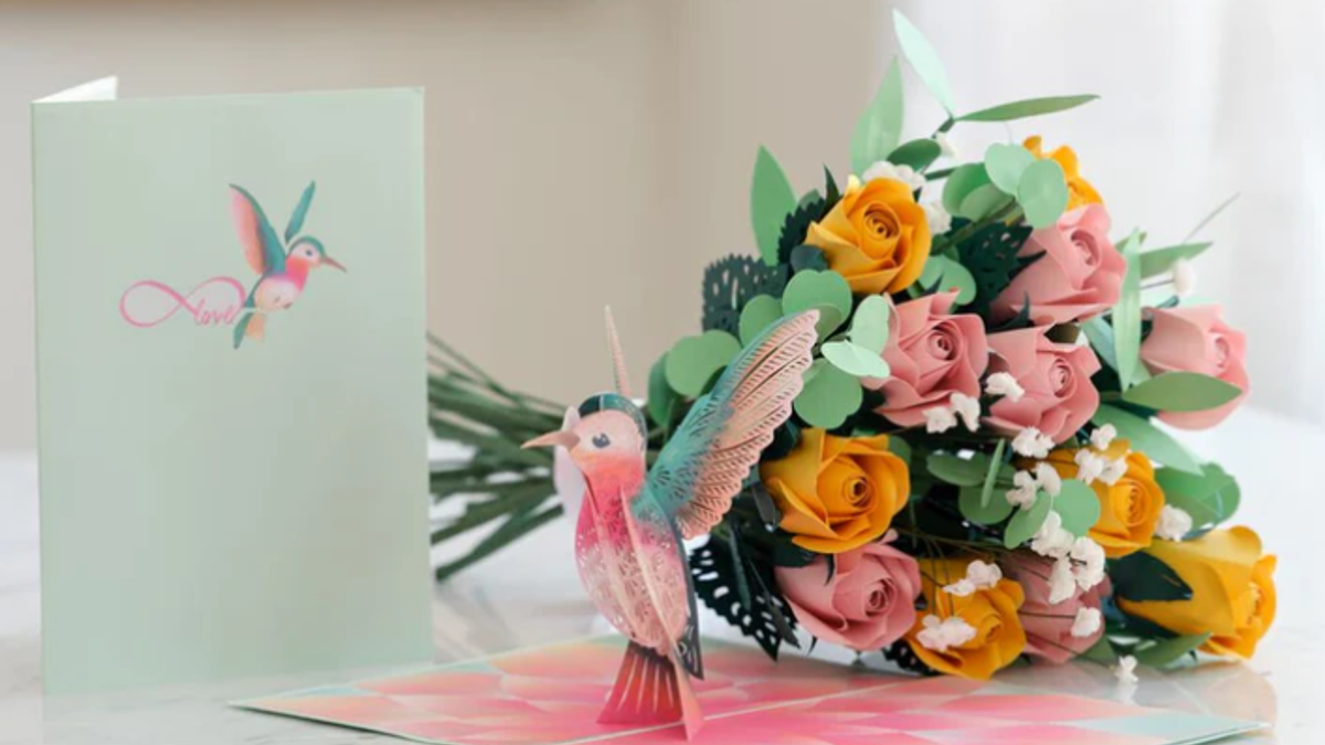 This delicate card and bouquet are crafted out of paper.