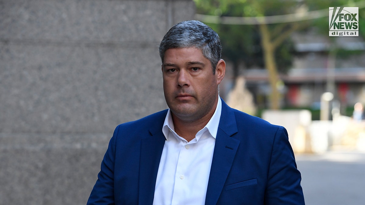 P. Diddy's assistant enters the courthouse to testify at the trial.