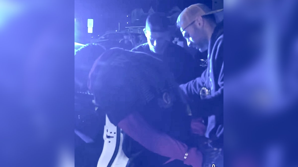 police detain man near car