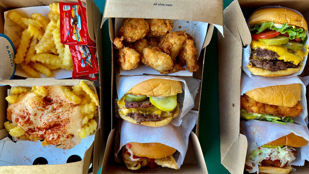 An assortment of Shake Shack burgers and finger foods.