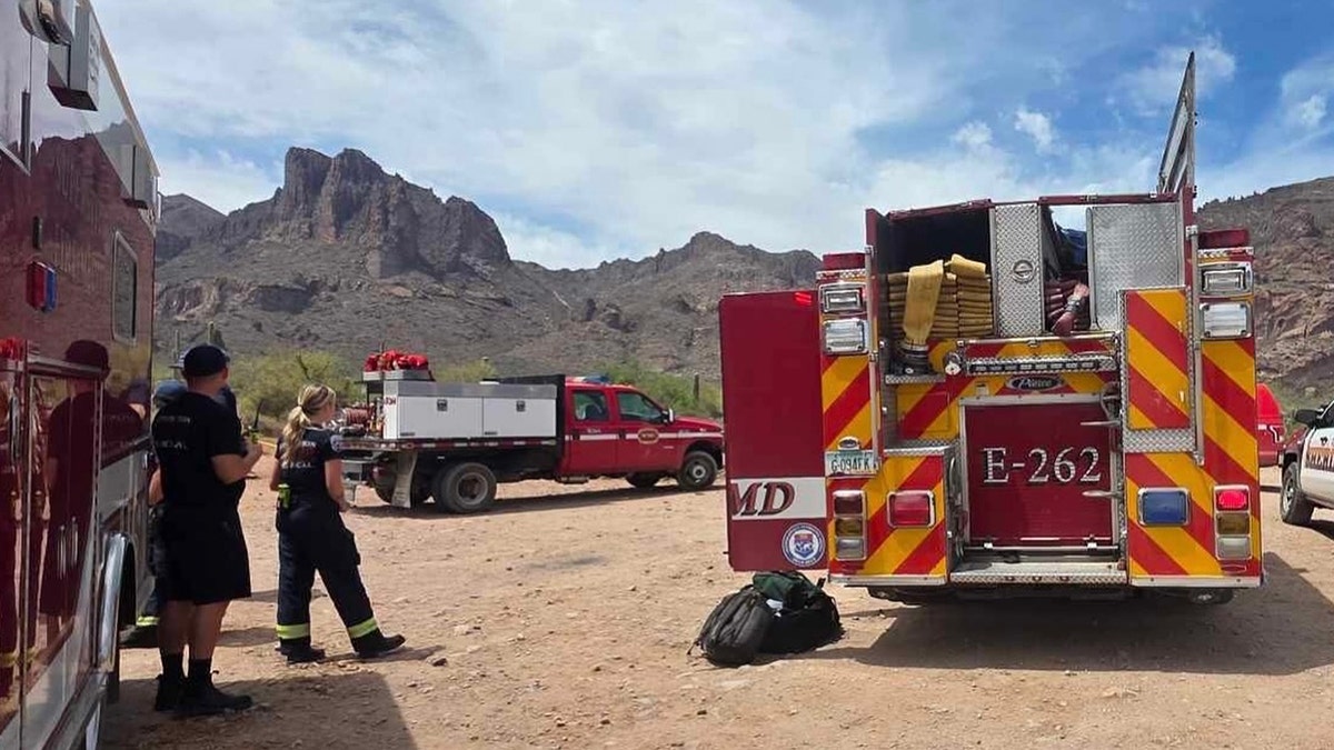 Superstition Fire and Medical responders standing near emergency vehicles at mountains