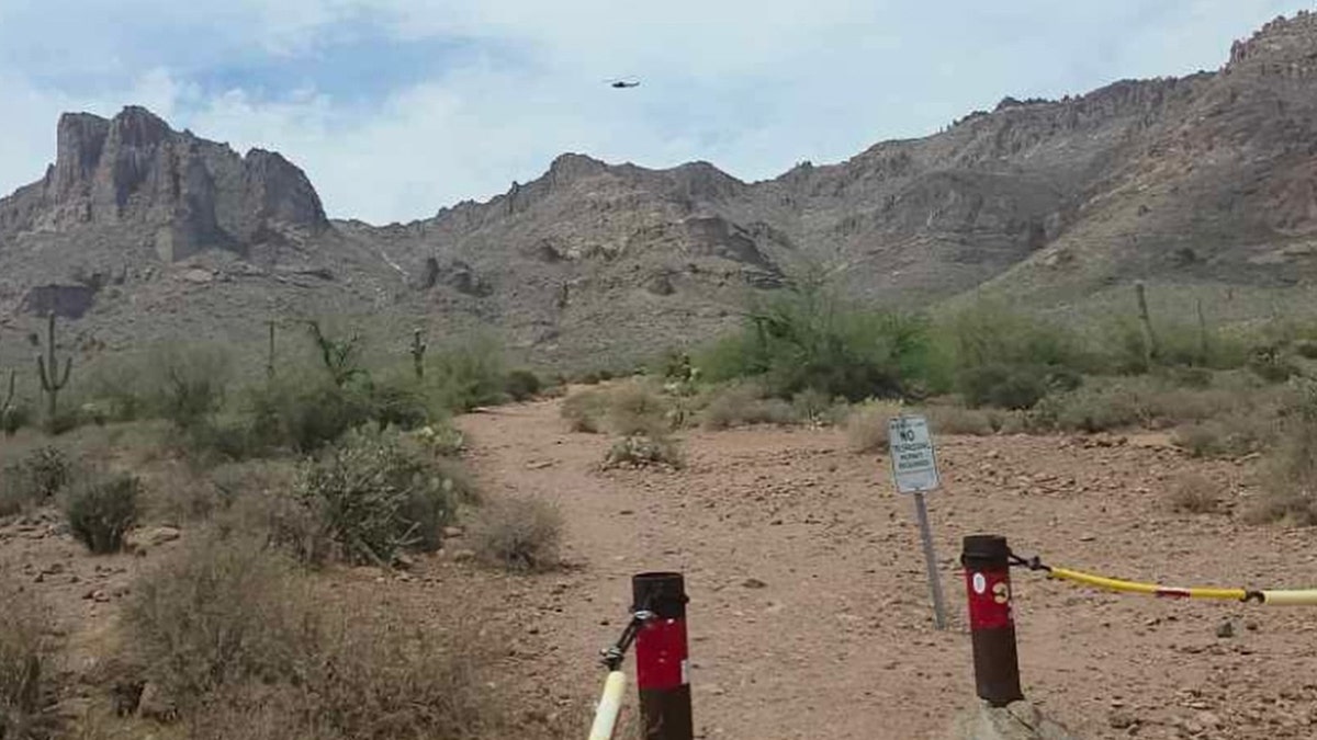helicopter in the distance flying over Superstition Mountains