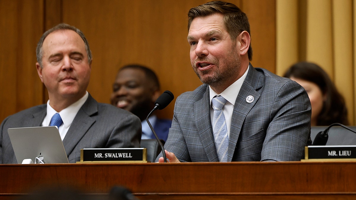 Rep. Eric Swalwell in grey suit speaking