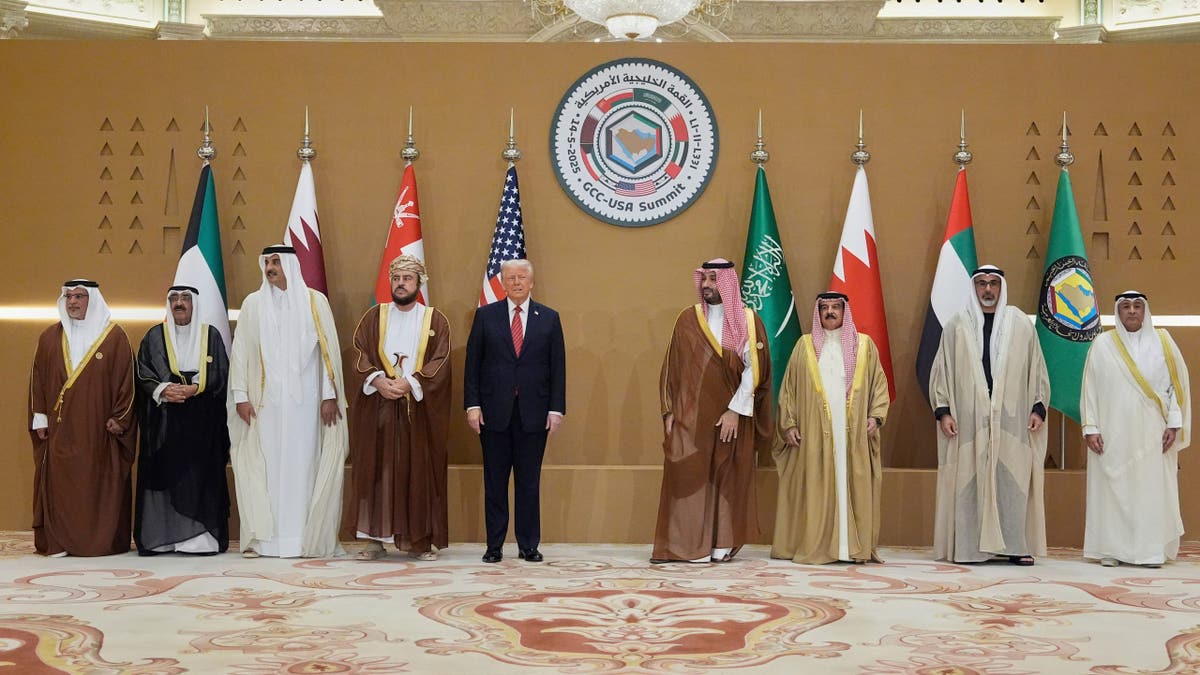 President Donald Trump, center, attends a photo session in Saudi Arabia