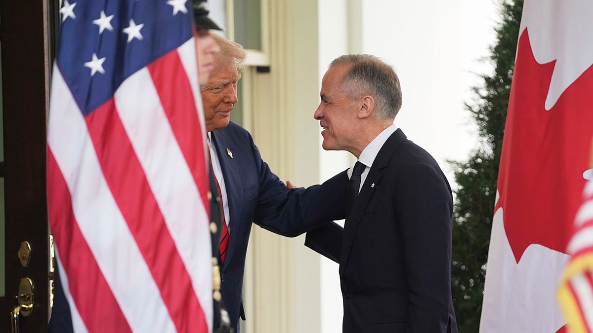 Trump places hand on Carney's shoulder outside White House