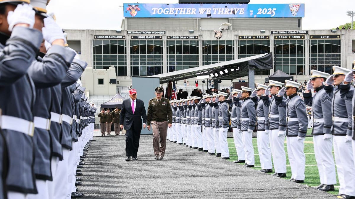 President Donald Trump walks with superintendent Lieutenant General Steven W. Gilland after addressing graduates of the United States Military Academy at West Point 