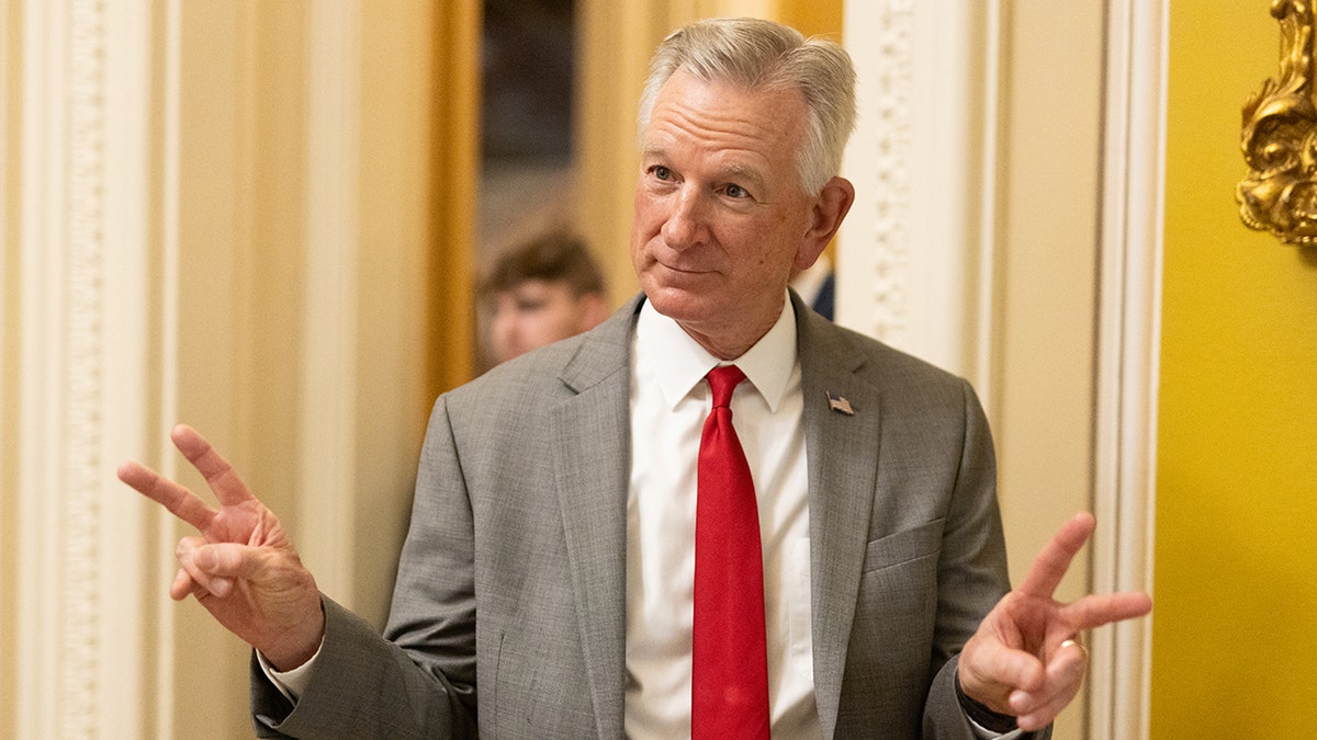Sen. Tommy Tuberville holding peace signs