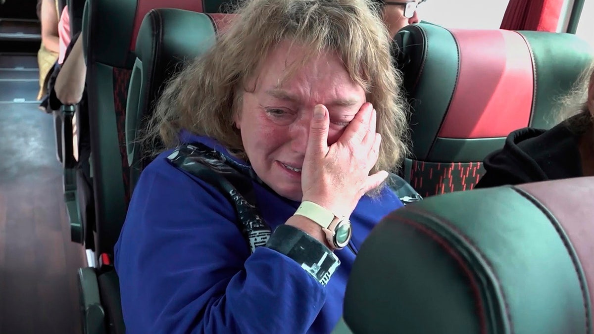 Woman cries after being released in prisoner swap