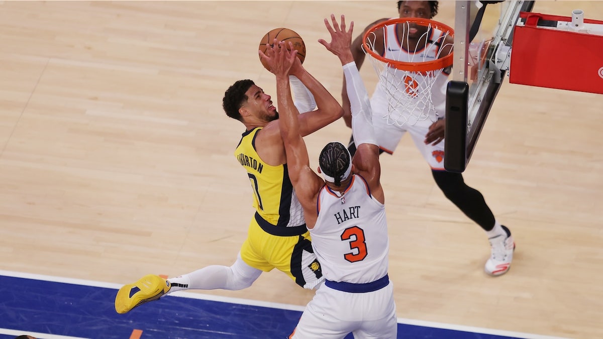 May 21, 2025; New York, New York, USA; Indiana Pacers guard Tyrese Haliburton (0) shoots against New York Knicks guard Josh Hart (3) in overtime during game one of the eastern conference finals for the 2025 NBA Playoffs at Madison Square Garden. Mandatory Credit: Brad Penner-Imagn Images