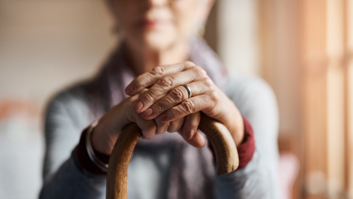 Older woman holding cane