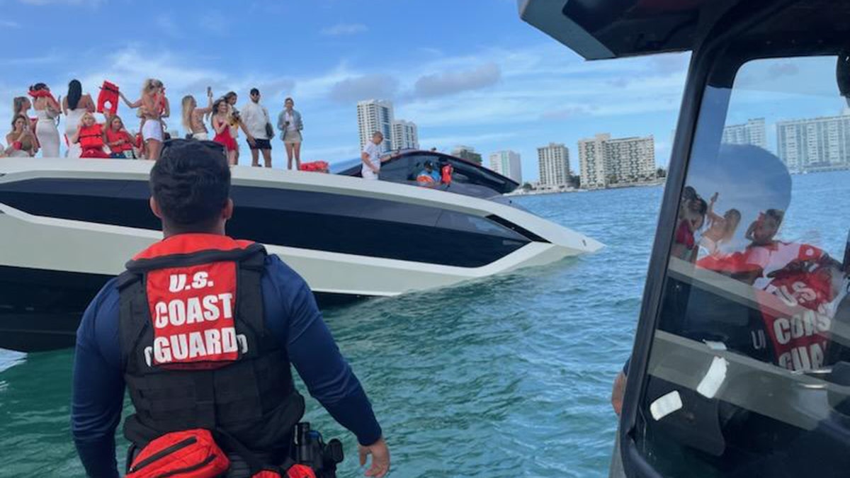 Coast Guard arrives to help people off sinking yacht