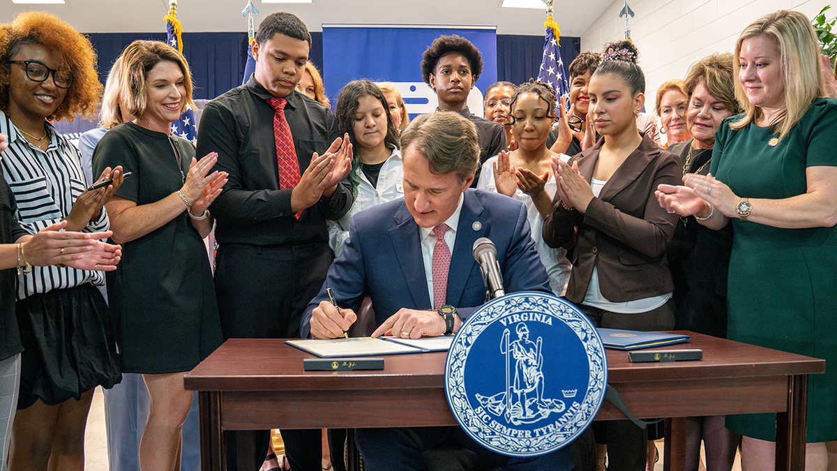 Gov. Glenn Youngkin signs a bill into law limiting cell phone use in Virginia public schools.