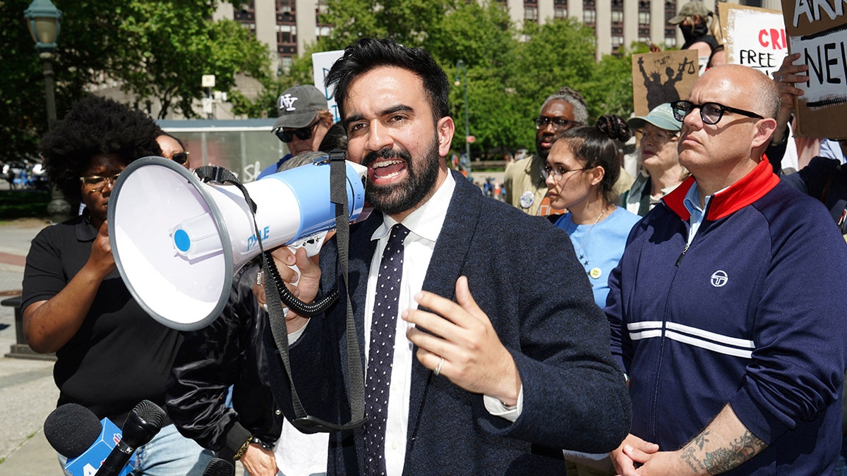 Zohran Mamdani speaking into a megaphone