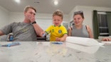 A father and mother react to their son as they take part in TikTok's "cookie challenge."