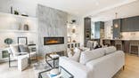 A modern contemporary living room with a fireplace and white furniture