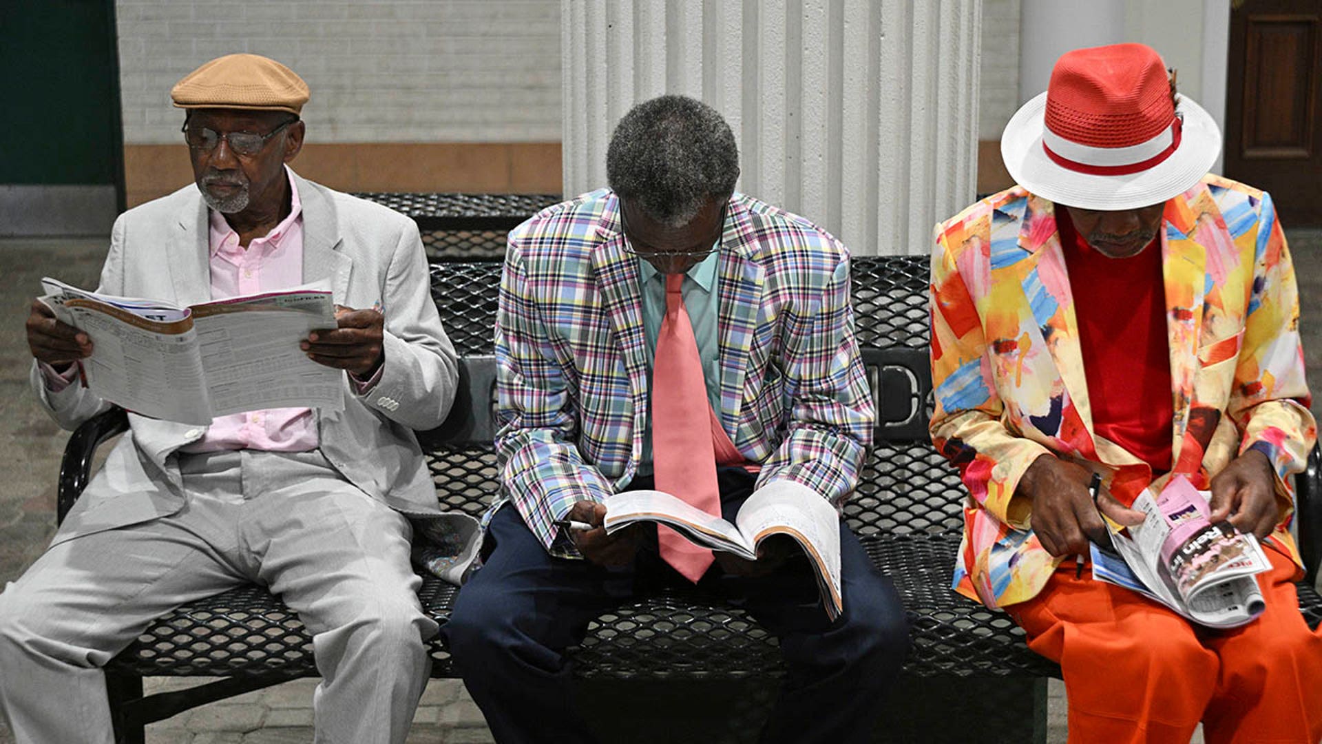 Fans looking over programs