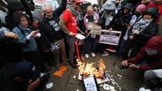 Anti-Israel protesters torch diplomas outside Columbia University on graduation day