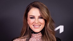 Elizabeth Hurley slips into a red bikini, ponders 'helluva few weeks' since Billy Ray Cyrus romance debut