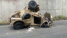 Two injured after military vehicle crashes over highway retaining wall, plunges 30 feet onto road below