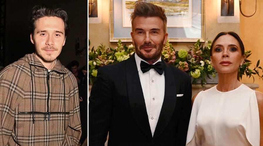 David Beckham waves to fans while walking the green carpet at the Earthshot Prize Awards