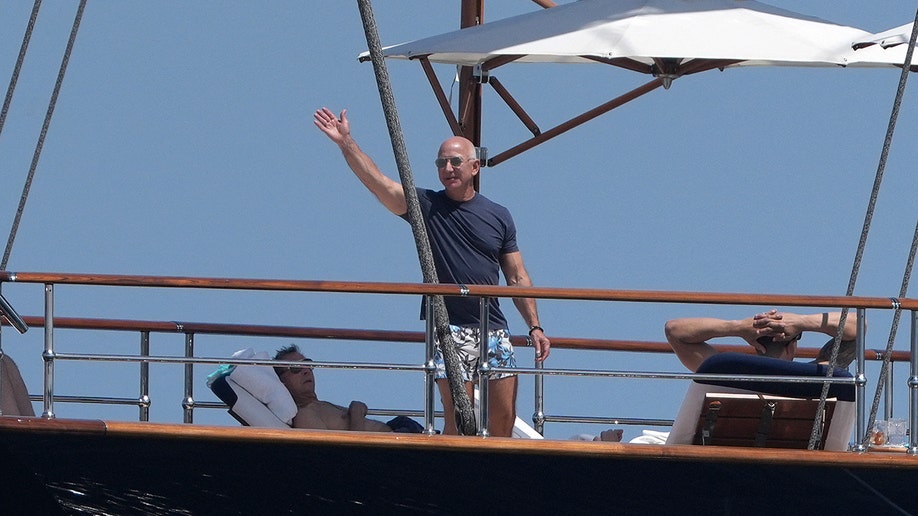 Jeff Bezos waving while on a boat