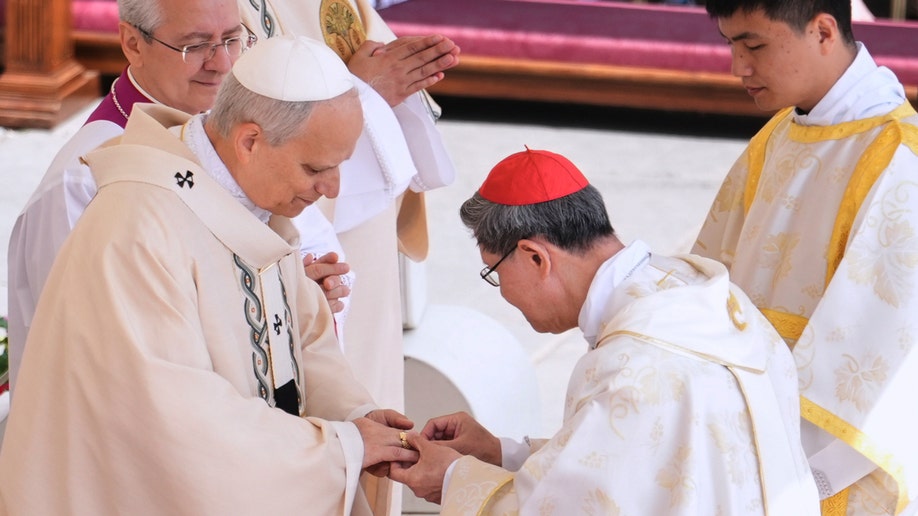 Cardinal Luis Antonio Tagle places the Ring of the Fisherman on the finger of Pope Leo XIV.