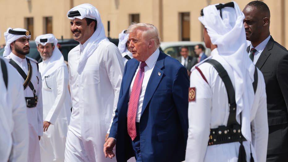 DOHA, QATAR - MAY 15: U.S. President Donald J. Trump speaks with Emir of Qatar Tamim bin Hamad al Thani as he departs the Al Udeid Air Base for Abu Dhabi on May 15, 2025, in Doha, Qatar