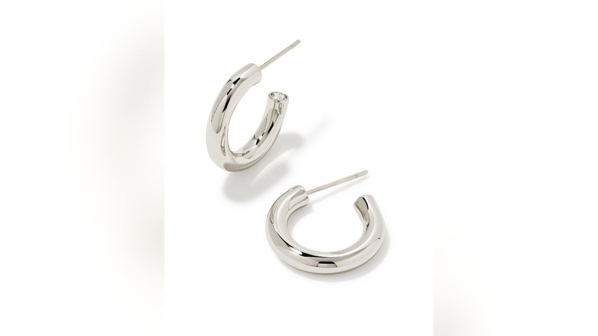 The Kendra Scott Colette style huggie earrings offer a sleek and polished huggie hoop look in silver or gold.