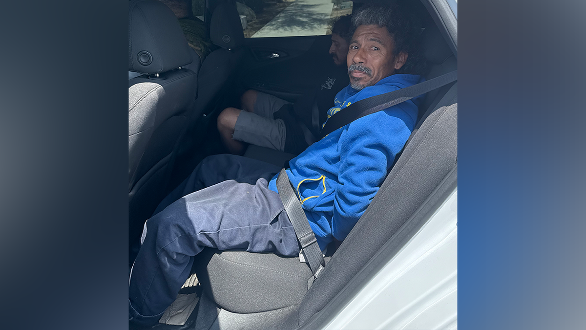 Arturo Terron-Quevedo sits in the back of a police car.