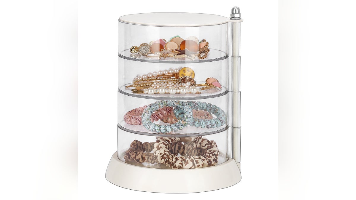 The stackable jewelry holder contains four round acrylic sections to accommodate different types of jewelry.
